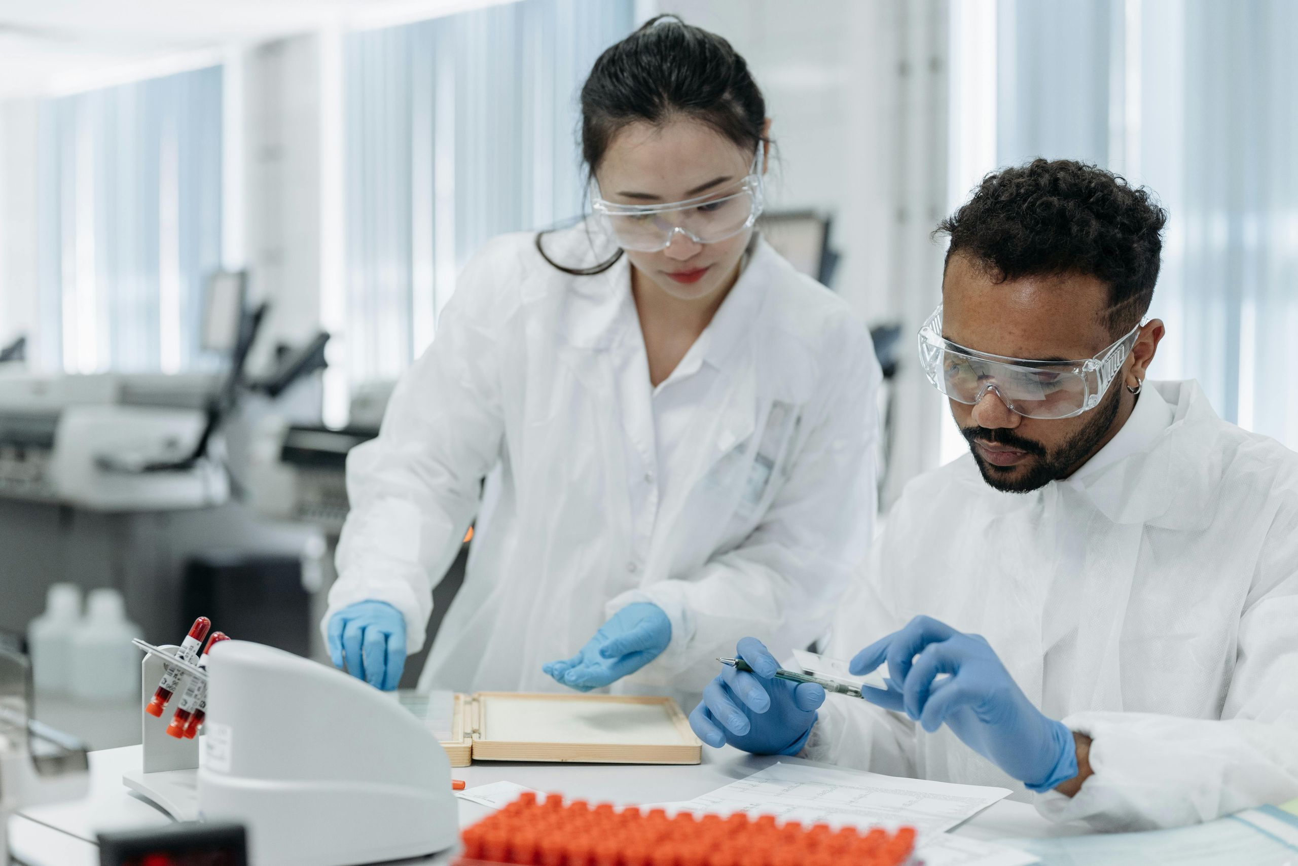 Black, Asian, and brown students collaborating in a research lab